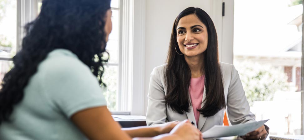 A financial advisor speaking with a woman.