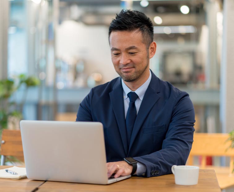 A man typing on a laptop computer