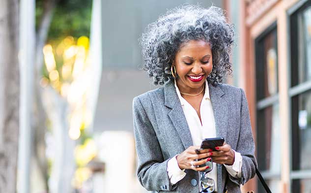 Business woman on street interacting with smartphone