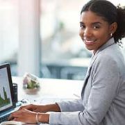 Business woman working at laptop smiling